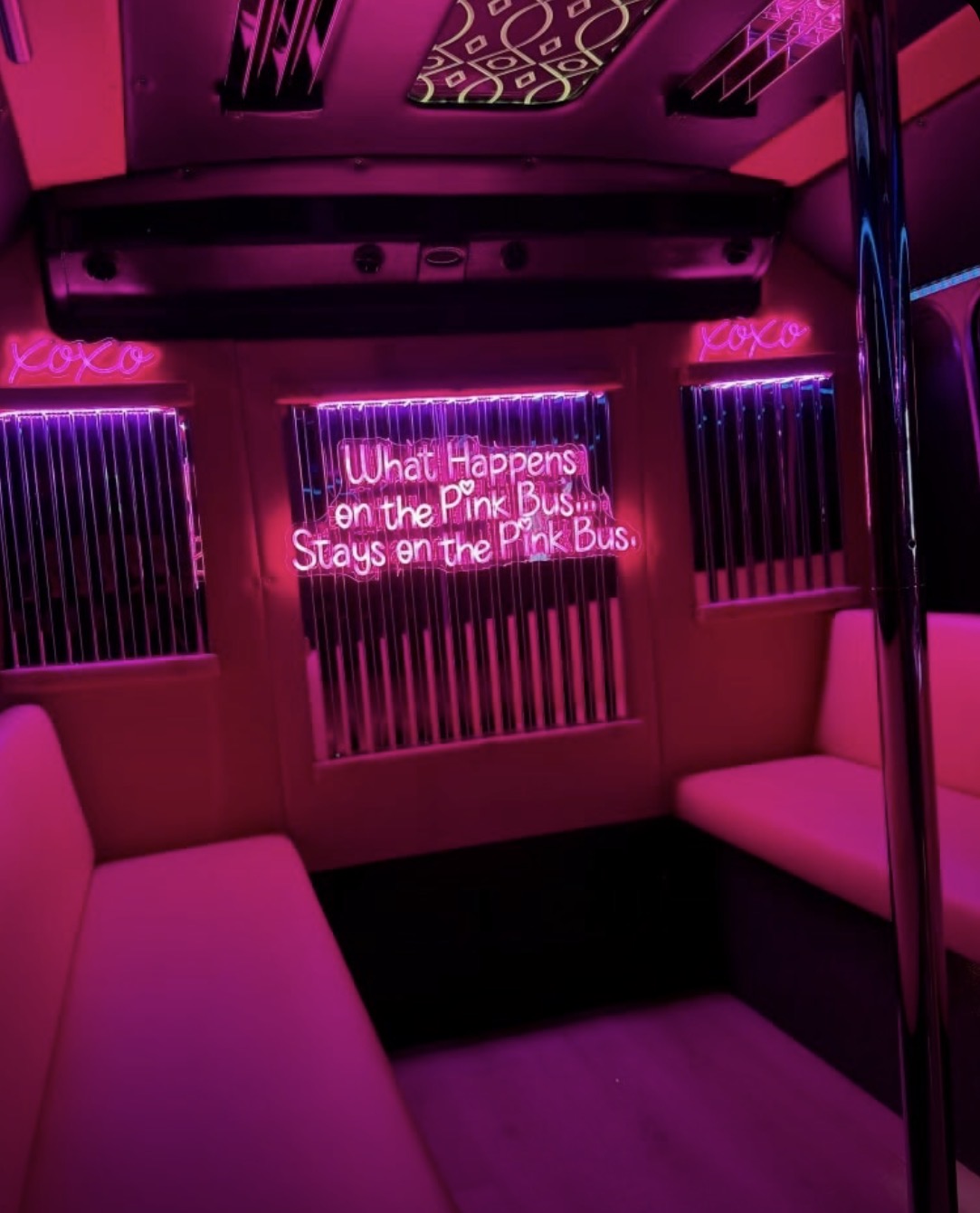 Pink-lit Scottsdale party bus interior with wraparound seating