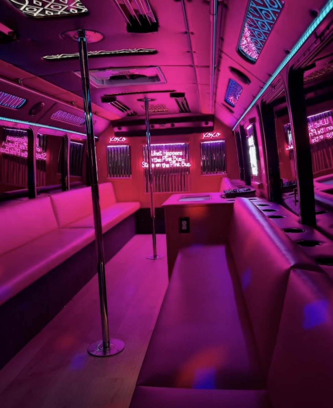 Party bus interior with disco lights and dance poles