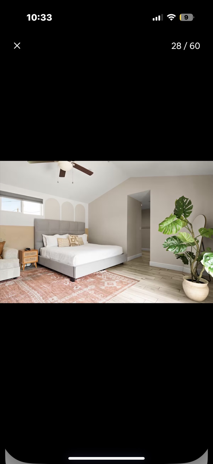 Airy bedroom with a large bed and sitting area