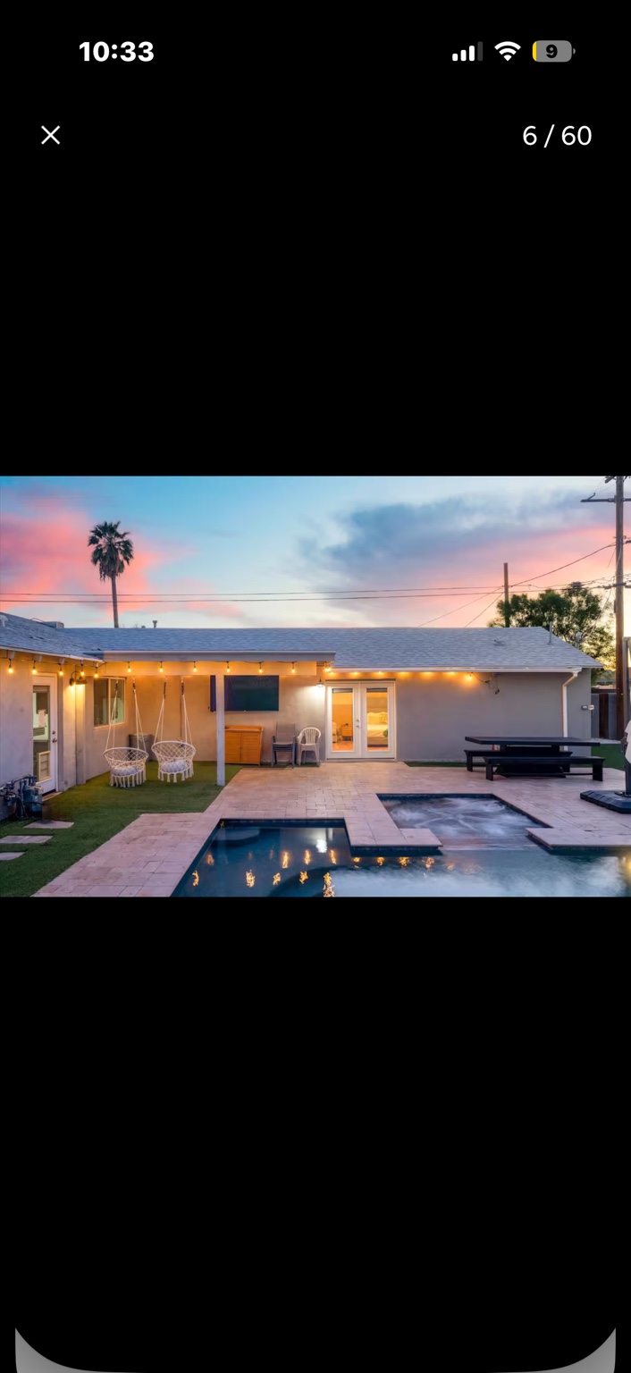 Backyard pool and covered patio at sunset